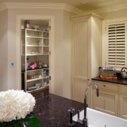 A view of this traditional kitchen featuring antique cabinetry, ceiling, countertop, floor, flooring, furniture, home, interior design, kitchen, room, window, brown