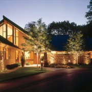 A pitched roof and new siding in wood architecture, building, cottage, estate, evening, facade, home, house, landscape lighting, lighting, mixed use, neighbourhood, night, property, real estate, residential area, roof, siding, sky, suburb, tree, window, black