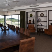 The boardroom, offices and production facilities are contained interior design, real estate, table, black, gray