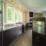 A view of the kitchen area, tiled floor, bathroom, cabinetry, ceiling, countertop, floor, flooring, home, interior design, kitchen, real estate, room, window, gray, black