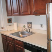 A view of the kitchen area before it cabinetry, countertop, cuisine classique, floor, furniture, hardwood, home, home appliance, kitchen, major appliance, property, room, sink, gray, red