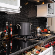 A view of this kitchen featuring black and countertop, interior design, kitchen, black, gray