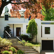 An exterior view of the entrance way to cottage, estate, facade, home, house, property, real estate, residential area, siding, tree, window, brown