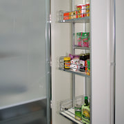 A view of this kitchen featuring cabinetry and display case, home appliance, kitchen appliance, major appliance, product, refrigerator, shelf, shelving, gray