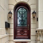 A view of an solid Mahogany entry door arch, door, estate, window, gray