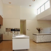 The island in this kitchen have benchtops of architecture, cabinetry, ceiling, countertop, daylighting, floor, home, interior design, kitchen, property, real estate, room, gray, brown