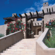 An exterior view of this Tuscan desert home, outdoor structure, property, roof, sky, gray