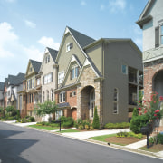 All homes in these neighborhoods are built by apartment, building, cottage, estate, facade, home, house, mixed use, neighbourhood, property, real estate, residential area, roof, siding, sky, suburb, window, gray