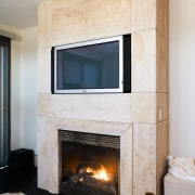 Large slabs of French limestone feature on the fireplace, floor, flooring, hearth, home, interior design, living room, wall, wood burning stove, gray