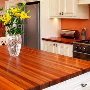 A view of this kitchen featuring blackwood timber cabinetry, countertop, floor, flooring, hardwood, interior design, kitchen, laminate flooring, table, wood, wood flooring, wood stain, red