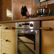 A view of a kitchen designed and manufactured cabinetry, countertop, gas stove, home appliance, kitchen, kitchen appliance, kitchen stove, major appliance, oven, brown