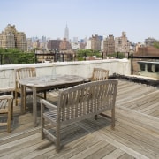 A view of the rooftop deck looking over apartment, condominium, deck, furniture, outdoor structure, property, real estate, roof, walkway, gray