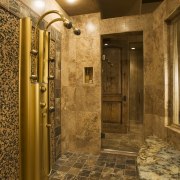 A view of this bathroom featuring gold wave bathroom, ceiling, floor, flooring, interior design, lighting, lobby, room, wall, brown