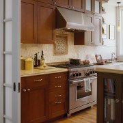 A view of a kitchen designed by Templer cabinetry, countertop, cuisine classique, flooring, furniture, hardwood, home appliance, interior design, kitchen, room, wood, brown, gray