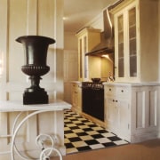 This kitchen sees classic wood cabinetry juxtaposed with floor, flooring, furniture, hardwood, home, interior design, living room, molding, room, table, wood flooring, brown, orange
