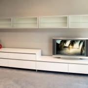 This cabinet offers storage for DVDs and CDs, fireplace, furniture, hearth, interior design, living room, product design, shelf, shelving, sideboard, gray