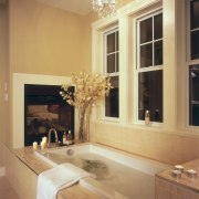 A view of the maser bathroom featuring tiled bathroom, ceiling, countertop, estate, floor, flooring, home, interior design, living room, room, wall, window, orange