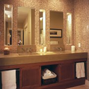A view of the maser bathroom featuring tiled bathroom, bathroom accessory, bathroom cabinet, cabinetry, flooring, furniture, interior design, room, sink, wall, orange, brown