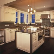 This kitchen combines contemporary and traditional materials, for cabinetry, countertop, cuisine classique, floor, flooring, hardwood, interior design, kitchen, laminate flooring, room, under cabinet lighting, wood, wood flooring, orange, black