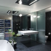 A view of the bathroom featuring tiled flooring, bathroom, ceiling, glass, interior design, room, black, gray