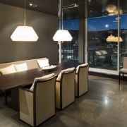 A view of the dining area featuring timber ceiling, floor, flooring, furniture, interior design, table, black, brown