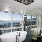 The bathroom features a fully mirrored wall, rain architecture, bathroom, glass, home, interior design, real estate, window, gray, black