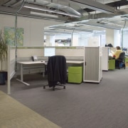 A view of this commercial office aspace featuring floor, flooring, office, gray