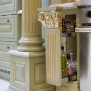 Gold leaf also features on all moldings and bathroom accessory, cabinetry, chest of drawers, drawer, floor, furniture, kitchen, room, shelf, shelving, brown, gray