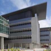 An exterior view of the greensquare building. The architecture, building, commercial building, condominium, corporate headquarters, daytime, elevation, facade, headquarters, metropolitan area, mixed use, real estate, sky, gray, teal