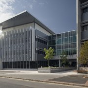 An exterior view of the greensquare building. Butler architecture, building, commercial building, condominium, corporate headquarters, facade, headquarters, mixed use, property, real estate, gray, black