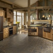 The richly hued Oiled Bronze collection of appliances cabinetry, countertop, cuisine classique, floor, flooring, hardwood, interior design, kitchen, laminate flooring, room, tile, wood flooring, brown