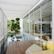 A pond is the focal point of two apartment, architecture, balcony, condominium, daylighting, house, interior design, real estate, window, white, gray