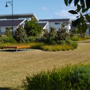 A view of these landscaped gardens and pool cottage, estate, grass, home, house, land lot, landscape, lawn, plant, property, real estate, residential area, tree, yard, brown