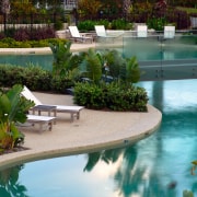 A view of these landscaped gardens and pool backyard, estate, landscape, landscaping, leisure, outdoor structure, plant, pond, real estate, resort, swimming pool, tree, water, water feature, teal