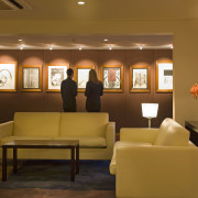 A view of the hotel lobby featuring parquet ceiling, furniture, interior design, living room, lobby, room, waiting room, brown