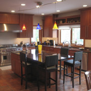 A view of this kitchen featuring a granite countertop, interior design, kitchen, room, table, red