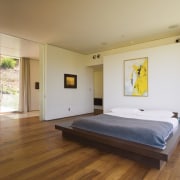 A view of this master bedroom featuring brazilian architecture, bed, bed frame, bedroom, ceiling, estate, floor, flooring, hardwood, house, interior design, laminate flooring, property, real estate, room, wood, wood flooring, gray, brown