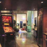 A view of the kitchen area, concrete flooring, electronic device, interior design, recreation room, room, black