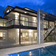 A view of a home by Santa Barbara apartment, architecture, building, elevation, estate, facade, family car, home, house, mixed use, property, real estate, residential area, swimming pool, villa, window, blue, gray