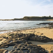 A view of the Coastal beaches located close beach, body of water, coast, coastal and oceanic landforms, headland, horizon, ocean, rock, sand, sea, shore, sky, water, white