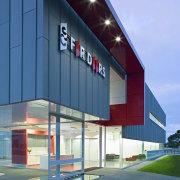 A number of functional and aesthietic motifs represent architecture, building, commercial building, corporate headquarters, elevation, facade, home, house, real estate, residential area, sky, teal