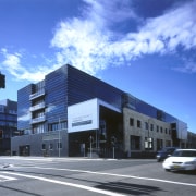 Seperate entrances for a community health centre and apartment, architecture, building, commercial building, condominium, corporate headquarters, daytime, downtown, elevation, facade, headquarters, house, metropolis, metropolitan area, mixed use, neighbourhood, property, real estate, residential area, sky, town, blue