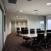 Large sliding doors allow the boardroom to be ceiling, conference hall, floor, flooring, interior design, office, real estate, gray, black