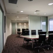 Large sliding doors allow the boardroom to be ceiling, conference hall, floor, flooring, interior design, office, real estate, gray, black