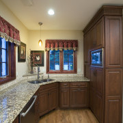 A view of this remodelled kitchen designed by cabinetry, ceiling, countertop, estate, floor, flooring, hardwood, home, interior design, kitchen, real estate, room, brown, gray