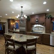 A view of this remodelled kitchen designed by cabinetry, countertop, cuisine classique, dining room, hardwood, home, interior design, kitchen, room, brown, gray