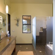 A view of this bathroom featuring tiled flooring, bathroom, floor, home, interior design, real estate, room, orange