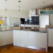 A view of this kitchen featuring the latest cabinetry, countertop, cuisine classique, interior design, kitchen, real estate, room, gray