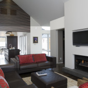 In this holiday house, the architects created focal hearth, house, interior design, living room, real estate, room, gray, black