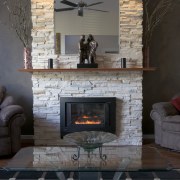 The ambience created by the look of natural fireplace, floor, flooring, hearth, home, interior design, living room, wall, wood burning stove, black, gray